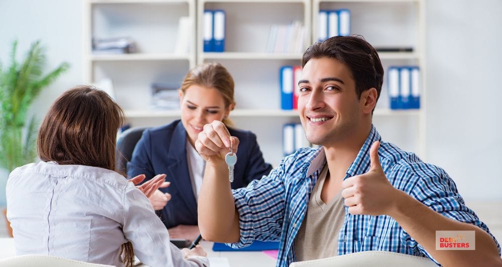 Happy man holding house keys, representing relief after overcoming mortgage stress in Australia families.