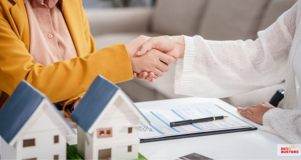 Handshake after approval of crisis loan for rent arrears to support housing stability.