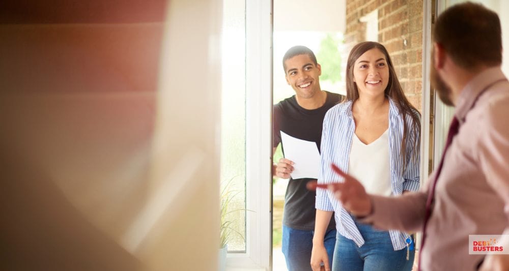 Happy tenants returning home after receiving crisis loan for rent arrears assistance.